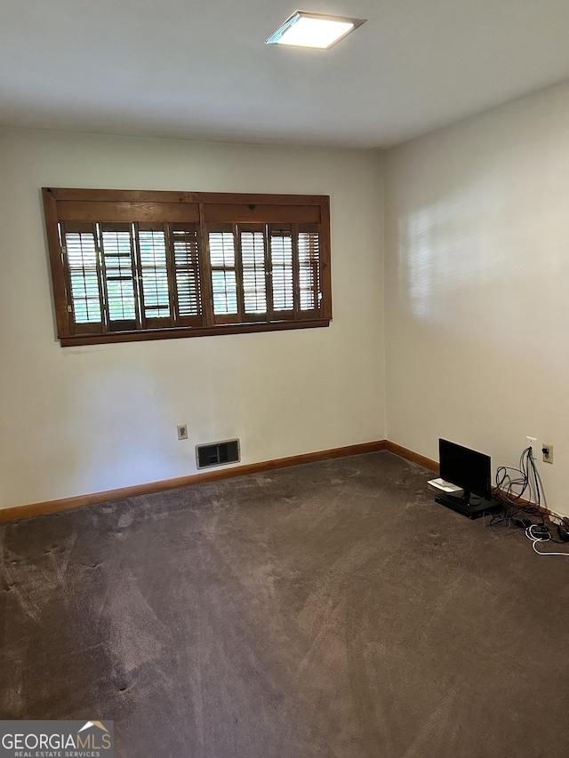2334 Connally Dr, East Point, GA 30344 - spare room featuring dark colored carpet and baseboards