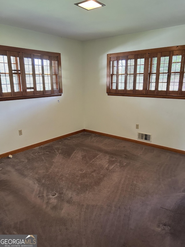 2334 Connally Dr, East Point, GA 30344 - spare room featuring healthy amount of natural light, baseboards, and dark colored carpet