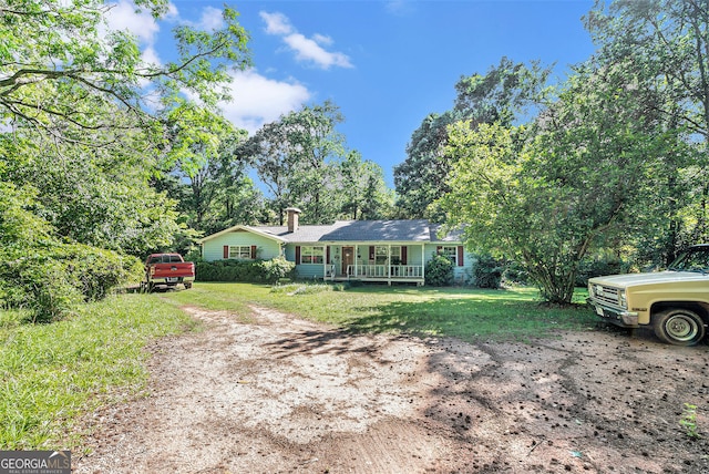 1387 Lanier Rd, Pendergrass, GA 30567 - ranch-style house with covered porch, a front lawn, a chimney, and driveway
