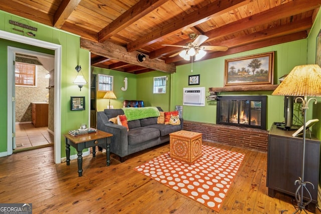 3644 Bert Dr, Gainesville, GA 30506 - living room featuring a wood ceiling with exposed beams, hardwood / wood-style flooring, a brick fireplace, a wall mounted AC, and ceiling fan