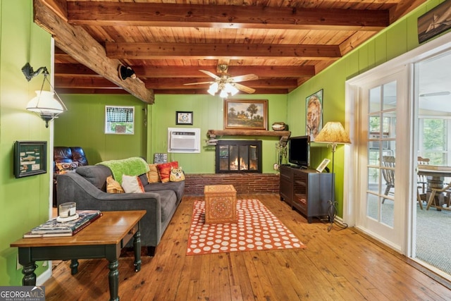 3644 Bert Dr, Gainesville, GA 30506 - living area featuring wood-type flooring, a wood ceiling with exposed beams, an AC wall unit, a ceiling fan, and a glass covered fireplace
