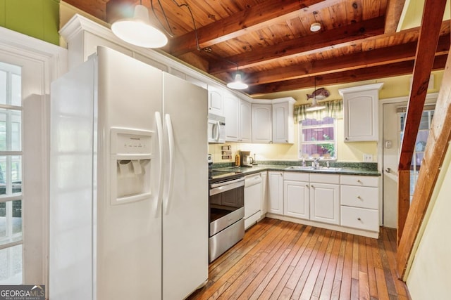 3644 Bert Dr, Gainesville, GA 30506 - kitchen with white appliances, a wooden ceiling with exposed beams, dark countertops, healthy amount of natural light, and light wood-style flooring