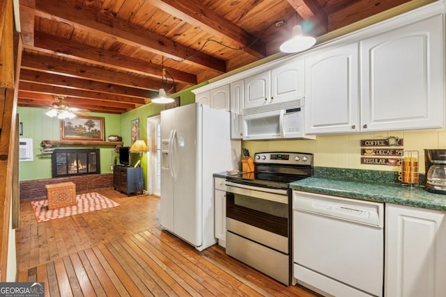 3644 Bert Dr, Gainesville, GA 30506 - kitchen featuring white appliances, light wood-style flooring, a wooden ceiling with exposed beams, dark countertops, and white cabinetry