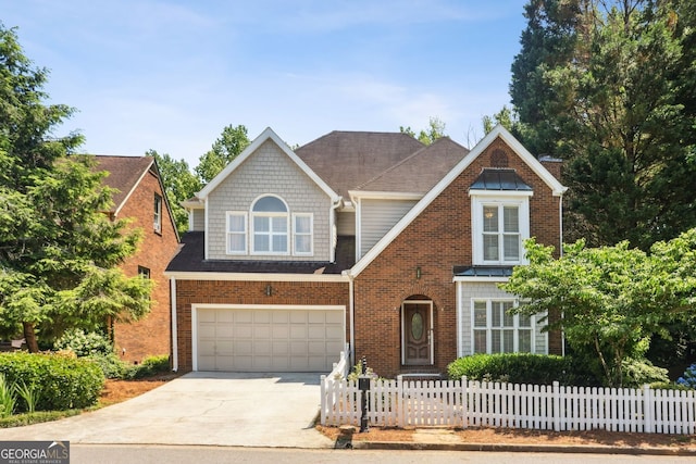 2567 Briers N Dr, Dunwoody, GA 30360 - view of front of home with concrete driveway, an attached garage, and brick siding