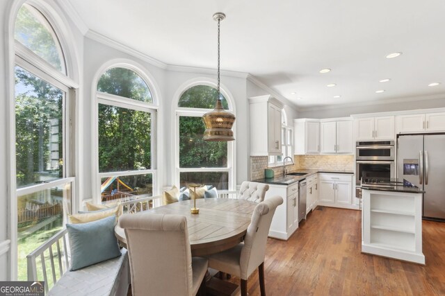 2567 Briers N Dr, Dunwoody, GA 30360 - dining space with crown molding, wood finished floors, and recessed lighting