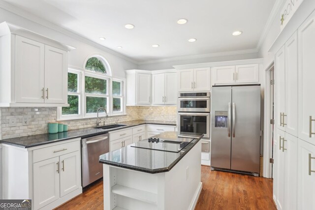 2567 Briers N Dr, Dunwoody, GA 30360 - kitchen with appliances with stainless steel finishes, a sink, open shelves, white cabinets, and ornamental molding