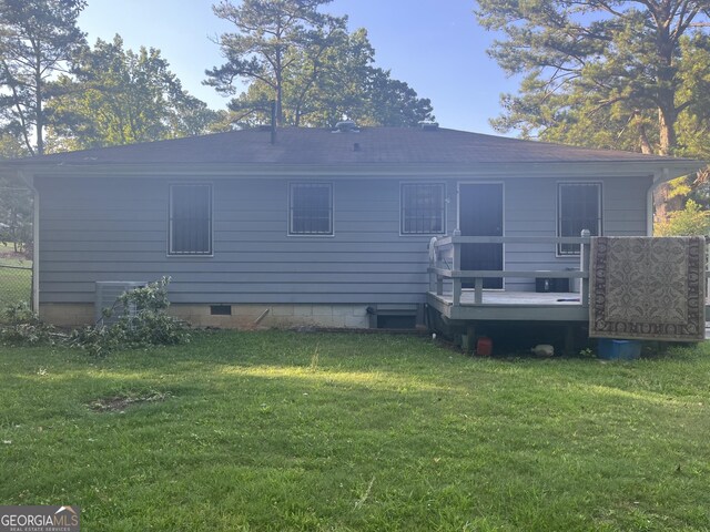 2530 Old Colony Rd, East Point, GA 30344 - rear view of house with a wooden deck, a yard, and central air condition unit
