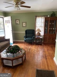 2530 Old Colony Rd, East Point, GA 30344 - living area featuring a ceiling fan, wood finished floors, baseboards, and crown molding