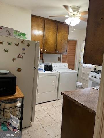2530 Old Colony Rd, East Point, GA 30344 - laundry area with independent washer and dryer, light tile patterned floors, and ceiling fan