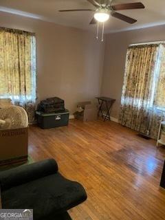 2530 Old Colony Rd, East Point, GA 30344 - living room with a ceiling fan, wood finished floors, and baseboards