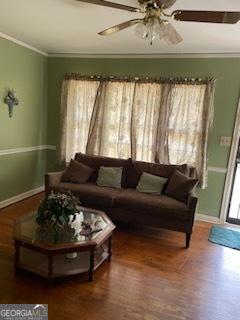 2530 Old Colony Rd, East Point, GA 30344 - living area featuring crown molding, wood finished floors, ceiling fan, and baseboards