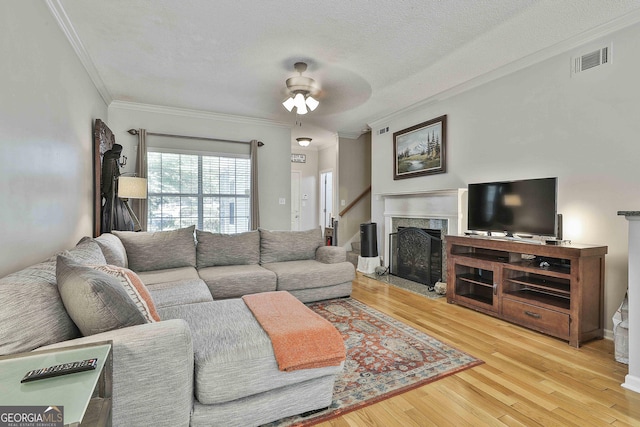 508 Las Brasis Ct, Peachtree City, GA 30269 - living area featuring crown molding, a premium fireplace, wood finished floors, a ceiling fan, and a textured ceiling