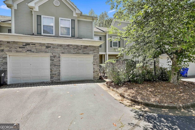 508 Las Brasis Ct, Peachtree City, GA 30269 - view of front of property featuring driveway, stone siding, and an attached garage