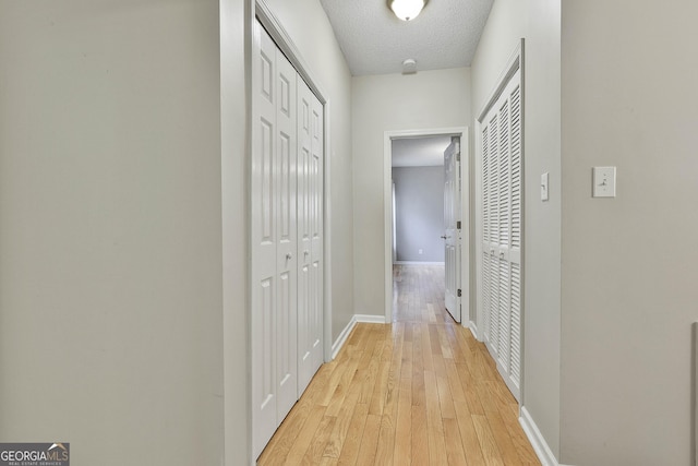 508 Las Brasis Ct, Peachtree City, GA 30269 - corridor featuring light wood finished floors, baseboards, and a textured ceiling