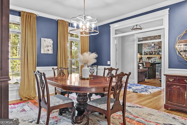 155 Bear Paw Ct, Clarkesville, GA 30523 - dining room featuring wood finished floors, a chandelier, healthy amount of natural light, ornamental molding, and wainscoting
