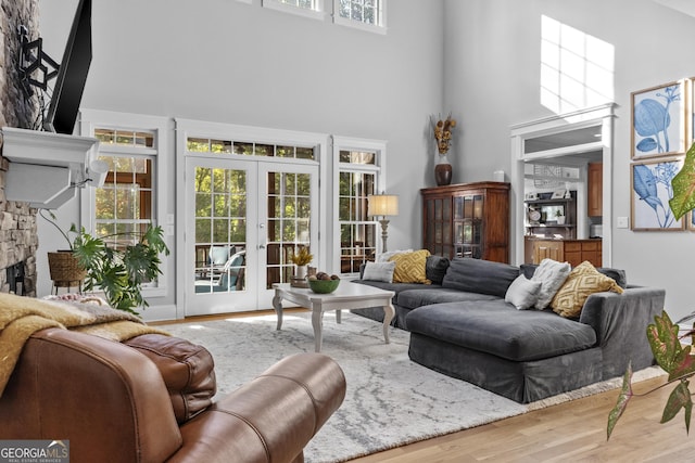 155 Bear Paw Ct, Clarkesville, GA 30523 - living area with a high ceiling, wood finished floors, a stone fireplace, and french doors