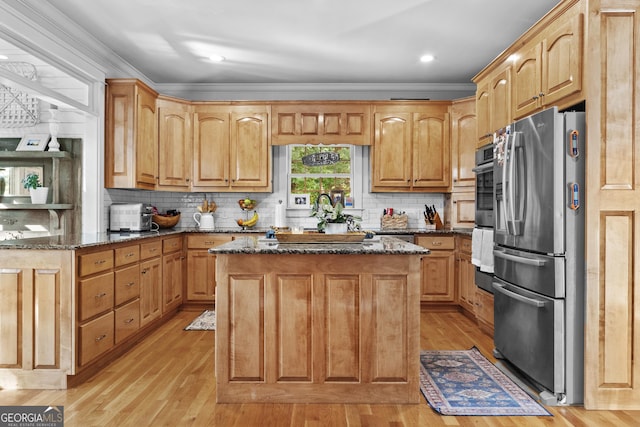 155 Bear Paw Ct, Clarkesville, GA 30523 - kitchen with freestanding refrigerator, dark stone counters, light wood-style floors, a kitchen island, and backsplash