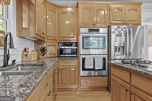 155 Bear Paw Ct, Clarkesville, GA 30523 - kitchen with appliances with stainless steel finishes, a sink, dark stone countertops, light wood-type flooring, and tasteful backsplash
