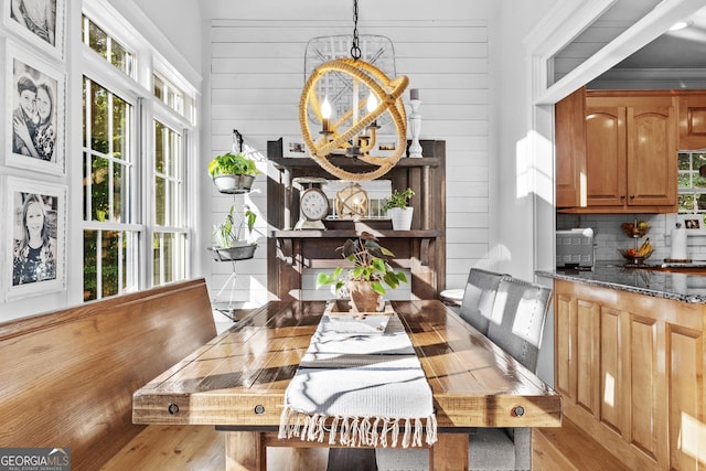 155 Bear Paw Ct, Clarkesville, GA 30523 - dining space with light wood finished floors, a chandelier, and wood walls