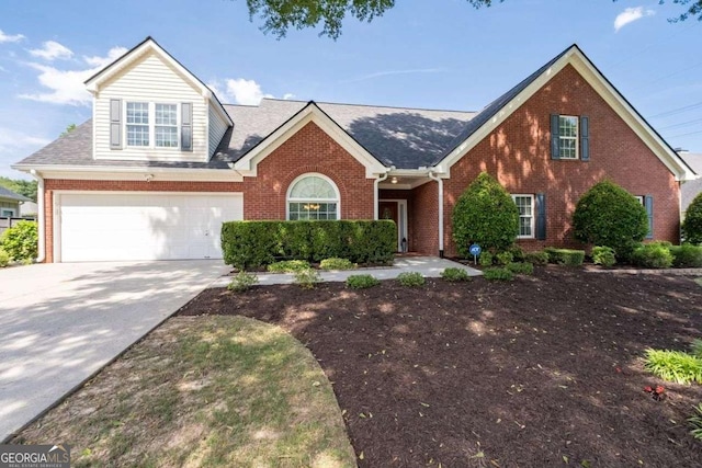 3027 Biltmore Woods Dr, Buford, GA 30519 - traditional-style home with brick siding, concrete driveway, and a garage