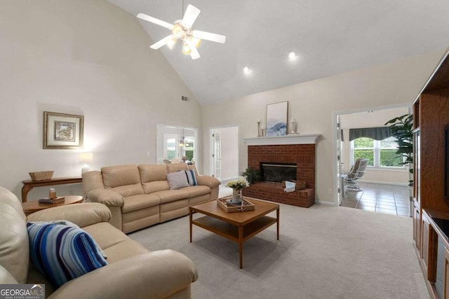 3027 Biltmore Woods Dr, Buford, GA 30519 - living room with high vaulted ceiling, a fireplace, a ceiling fan, and light colored carpet