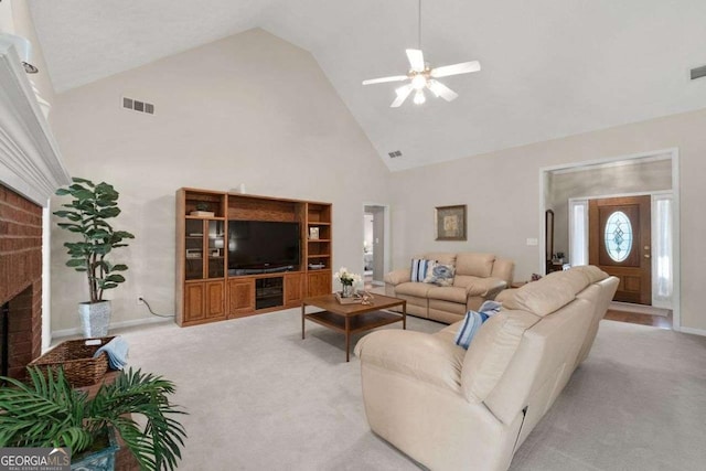 3027 Biltmore Woods Dr, Buford, GA 30519 - living room with high vaulted ceiling, ceiling fan, light carpet, a brick fireplace, and baseboards