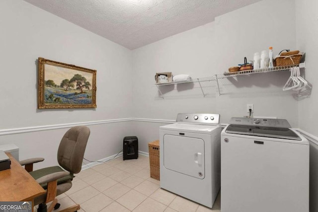 3027 Biltmore Woods Dr, Buford, GA 30519 - laundry room featuring washer and dryer, a textured ceiling, baseboards, and light tile patterned floors