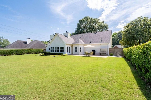 3027 Biltmore Woods Dr, Buford, GA 30519 - back of property featuring a patio and a chimney