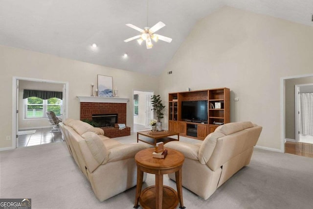 3027 Biltmore Woods Dr, Buford, GA 30519 - living area with high vaulted ceiling, a ceiling fan, baseboards, a fireplace, and light carpet