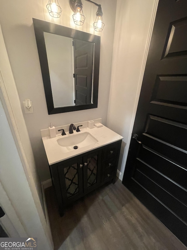 1333 Happy Hill Rd, Carrollton, GA 30116 - bathroom featuring wood finished floors, vanity, and baseboards