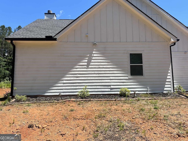 1333 Happy Hill Rd, Carrollton, GA 30116 - view of side of property featuring a shingled roof, a chimney, and board and batten siding