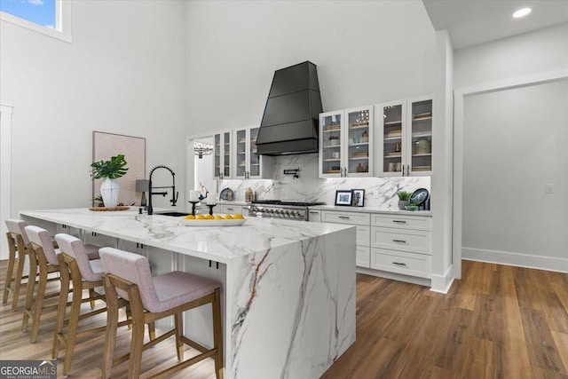 1604 Greendale Rd, Covington, GA 30014 - kitchen featuring custom range hood, white cabinets, stove, tasteful backsplash, and a high ceiling