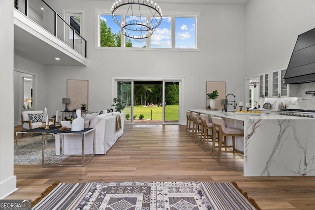 1604 Greendale Rd, Covington, GA 30014 - living room with a towering ceiling, light wood-style floors, and a chandelier