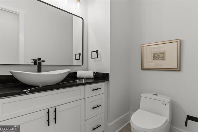 1604 Greendale Rd, Covington, GA 30014 - bathroom featuring vanity, toilet, and baseboards