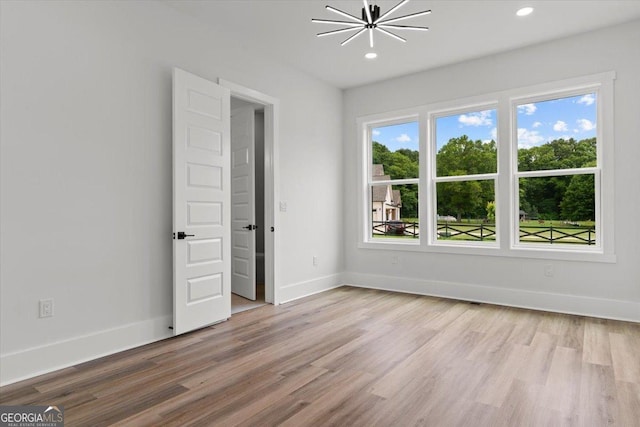 1604 Greendale Rd, Covington, GA 30014 - spare room featuring wood finished floors, baseboards, a chandelier, and recessed lighting