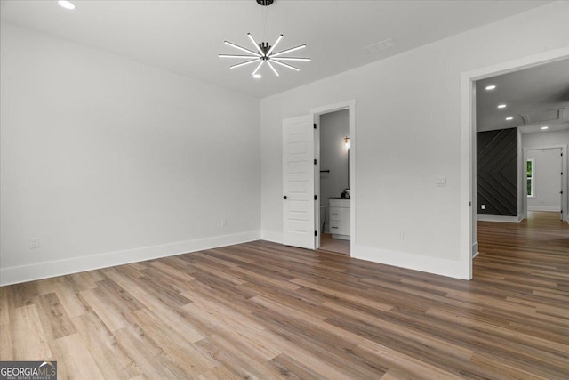 1604 Greendale Rd, Covington, GA 30014 - spare room with a chandelier, wood finished floors, recessed lighting, and baseboards