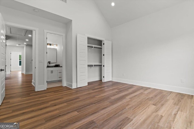 1604 Greendale Rd, Covington, GA 30014 - unfurnished bedroom with attic access, wood finished floors, recessed lighting, high vaulted ceiling, and baseboards