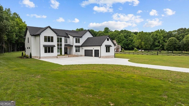1604 Greendale Rd, Covington, GA 30014 - modern farmhouse style home featuring a garage, a front yard, driveway, and board and batten siding