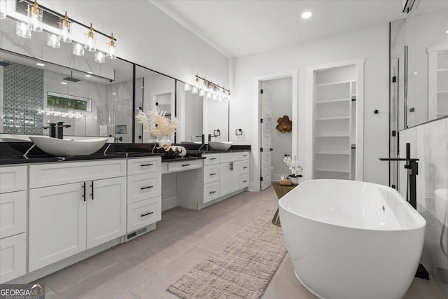 1604 Greendale Rd, Covington, GA 30014 - full bathroom with a stall shower, vanity, a freestanding bath, a walk in closet, and recessed lighting