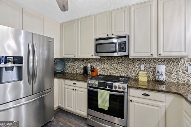 70 Otara Woods Ct, Newnan, GA 30263 - kitchen with stainless steel appliances, backsplash, dark wood-style floors, and dark stone counters