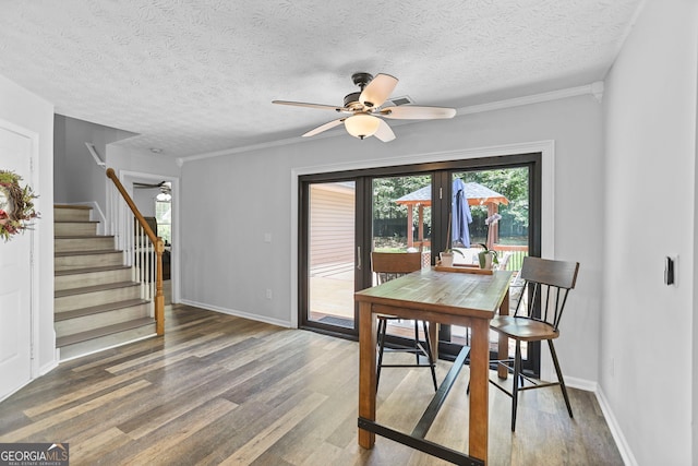 70 Otara Woods Ct, Newnan, GA 30263 - dining room featuring ceiling fan, wood finished floors, stairway, baseboards, and a textured ceiling