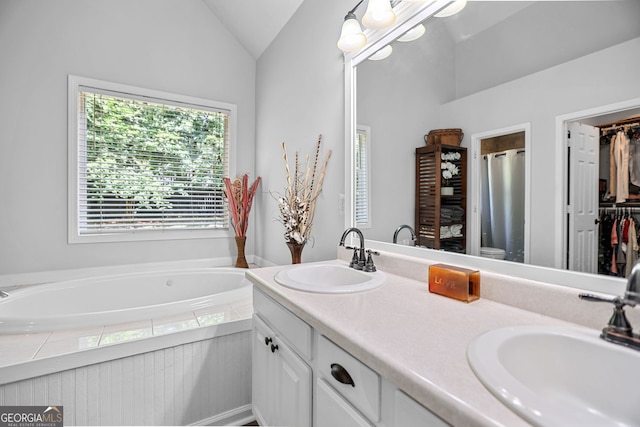 70 Otara Woods Ct, Newnan, GA 30263 - bathroom featuring lofted ceiling, a bath, double vanity, a shower stall, and a walk in closet
