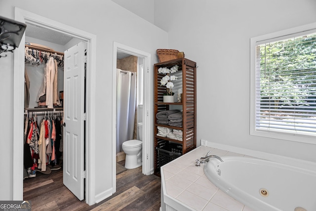 70 Otara Woods Ct, Newnan, GA 30263 - full bathroom with toilet, a jetted tub, a spacious closet, and wood finished floors
