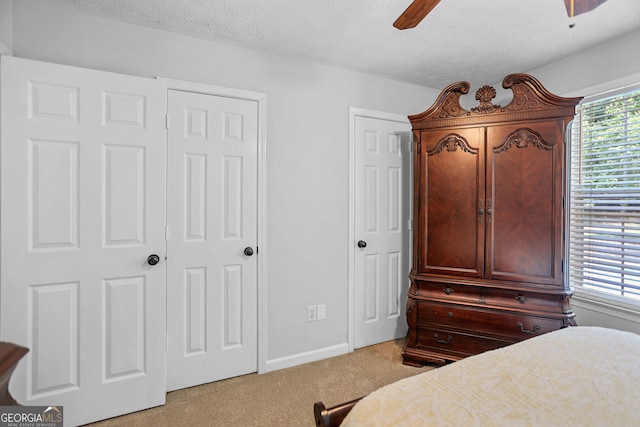 70 Otara Woods Ct, Newnan, GA 30263 - bedroom with light colored carpet, a textured ceiling, a ceiling fan, and baseboards