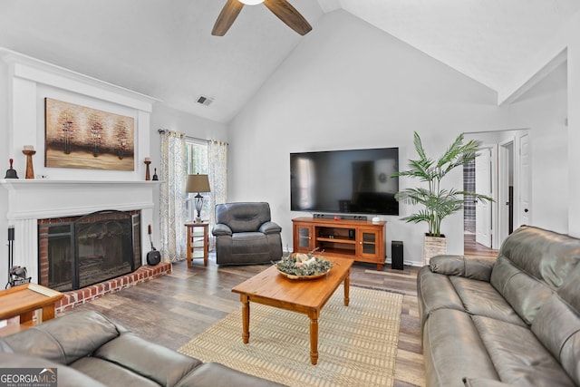 70 Otara Woods Ct, Newnan, GA 30263 - living area with wood finished floors, ceiling fan, high vaulted ceiling, and a fireplace
