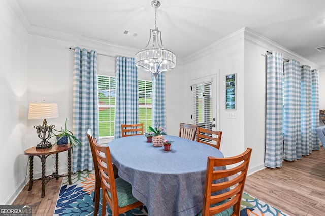 2036 Jefferson Hall Dr, Monroe, GA 30656 - dining area with wood finished floors, a chandelier, and ornamental molding