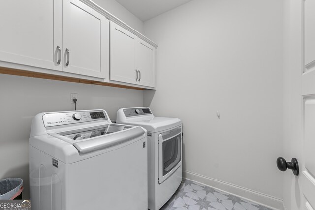 2036 Jefferson Hall Dr, Monroe, GA 30656 - laundry room featuring washer and dryer, cabinet space, and light flooring
