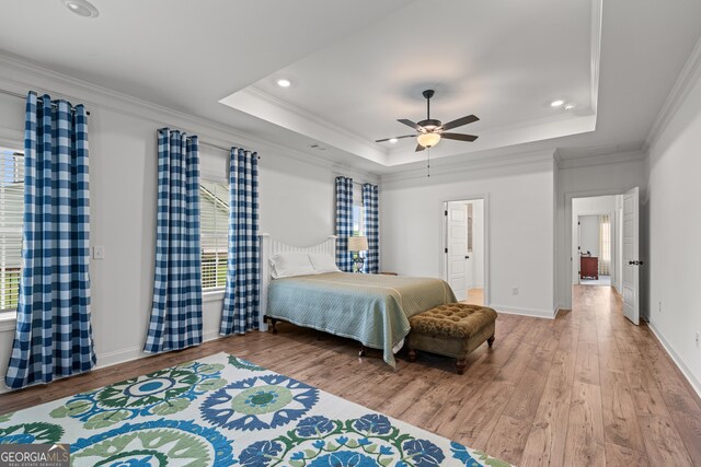 2036 Jefferson Hall Dr, Monroe, GA 30656 - bedroom featuring wood finished floors, ornamental molding, a tray ceiling, recessed lighting, and ceiling fan