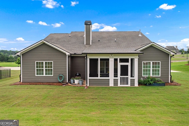 2036 Jefferson Hall Dr, Monroe, GA 30656 - rear view of house with a sunroom, a chimney, and a shingled roof