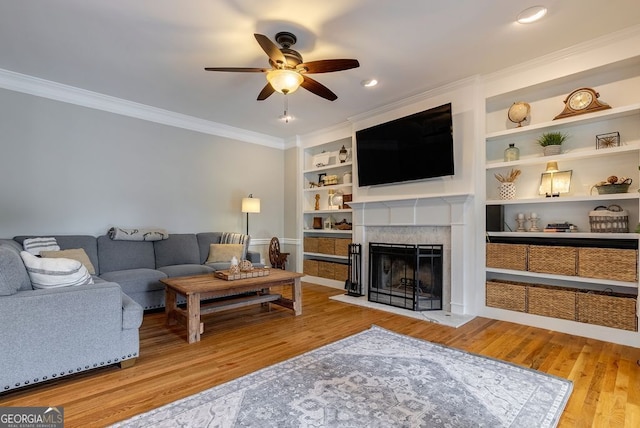 405 Woodbrook Way, Lawrenceville, GA 30043 - living area with ceiling fan, ornamental molding, wood finished floors, a fireplace, and built in shelves